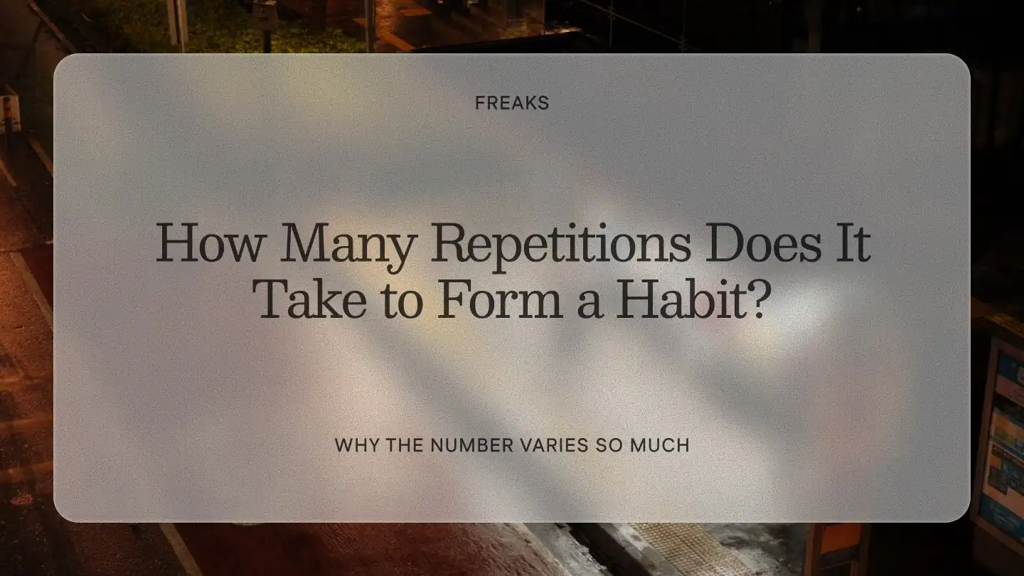 Freaks article title card reading 'How Many Repetitions Does It Take to Form a Habit?', with the subtitle 'Why the number varies so much', over a night city street